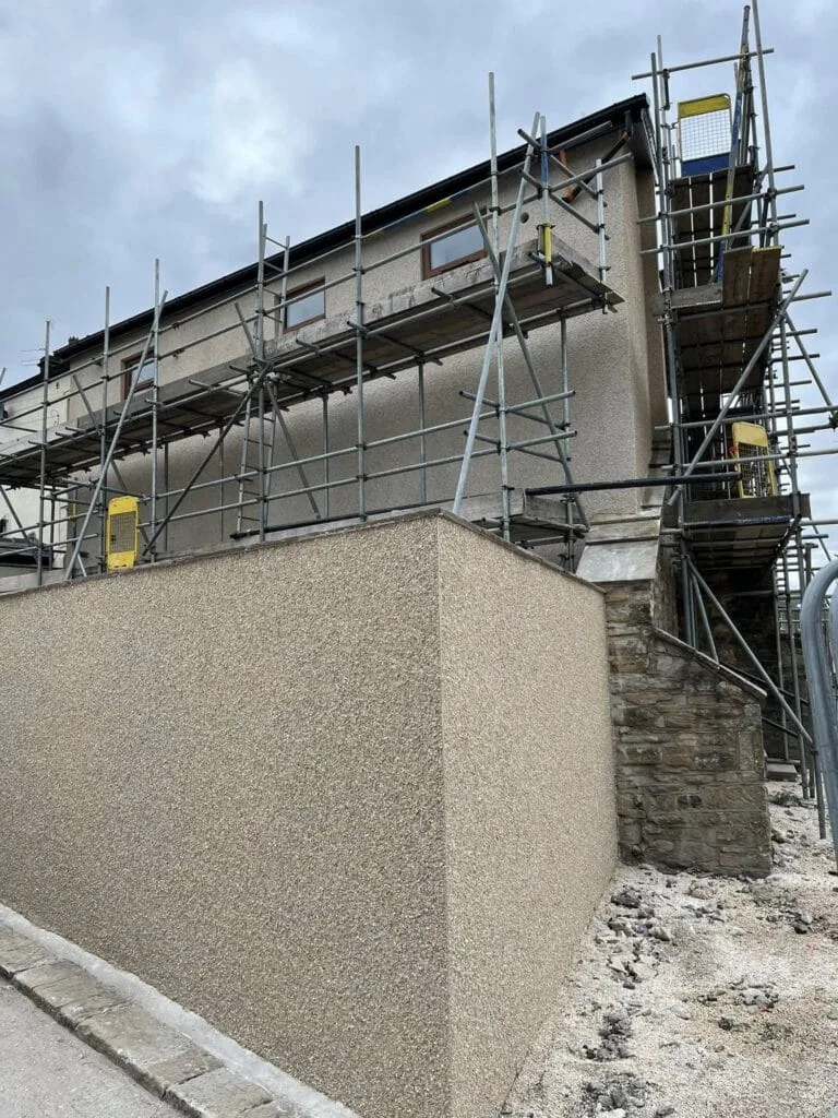 New pebble dash boundary wall finish