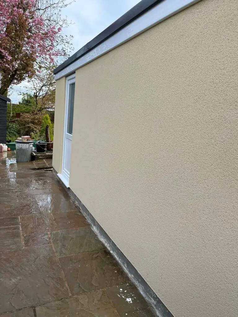 Newly rendered exterior wall on a garden extension