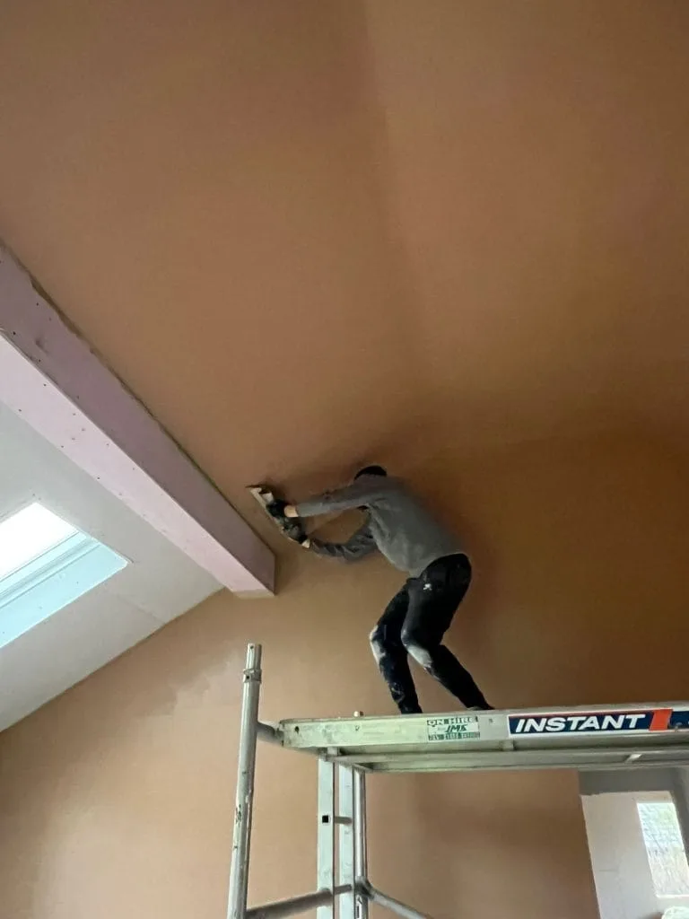 Plasterer skimming vaulted ceiling scaffolding tower
